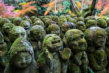 Fototapeta na wymiar Different faces of stone statutes in Otaji Nenbutsu-ji Temple