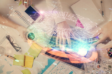 Double exposure of man's hands typing over computer keyboard and data theme hologram drawing. Top view. Technology concept.