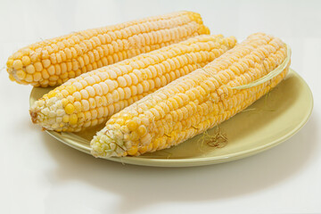Plate with frozen corn on plate with white background