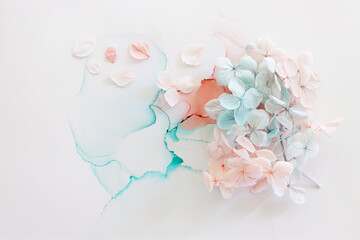 Fototapeta premium Creative image of pastel blue and pink Hydrangea flowers on artistic ink background. Top view with copy space