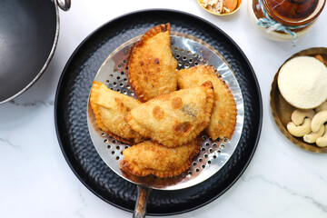 Indian Holi snack popuraly known as Gujia or Gujiya. Also called Karanji in Maharashtra, mostly...