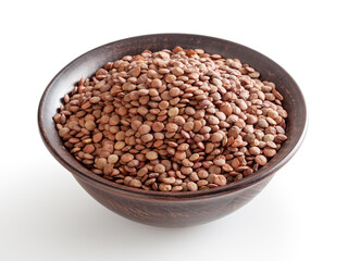Uncooked lentils in ceramic bowl isolated on white background with clipping path