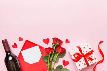 Valentine's day composition with red wine, rose flower and gift box on table. Top view, flat lay, copy space