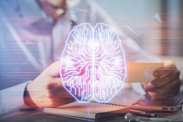 Obraz premium Double exposure of man's hand holding and using a digital device and brain hologram drawing. Data concept.