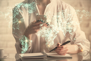 Double exposure of social network sketch hologram and woman holding and using a mobile device.