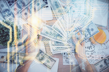 Double exposure of world map drawing hologram and us dollars bills and man hands.