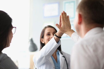 Colleagues give high five after successful agreement with partners