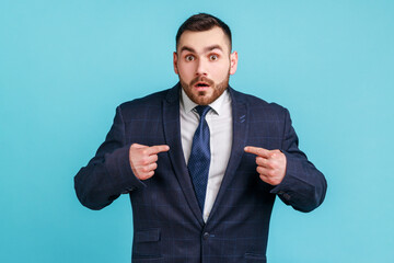 Wow, this is me! Portrait of astonished businessman in dark suit staring in amazement at camera and...