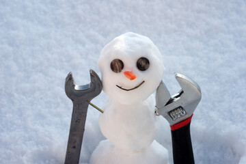 Little snowman with builder repair tools. Happy holiday and celebration.
