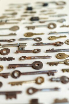 Antique keys are commonly reffered to as a bit or barrel keys, the former having a solid shrank and the latter being hollow. Here are some old antique and vintage keys against paper background.