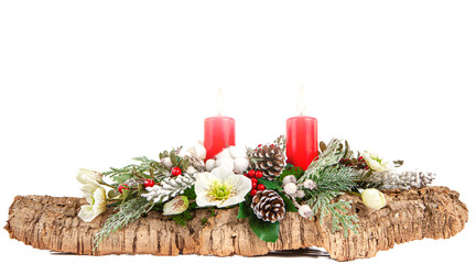 Christmas composition made with cork bark, pine, white flowers, red berries, red candles with hot flame, pine cones and snowy branches on isolated white background