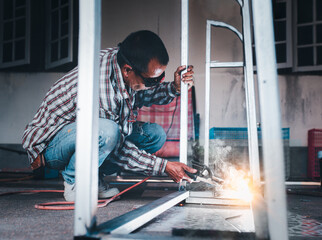 Industrial worker welding metal with many sharp sparks. Metal processing . Sparks in metalworking.