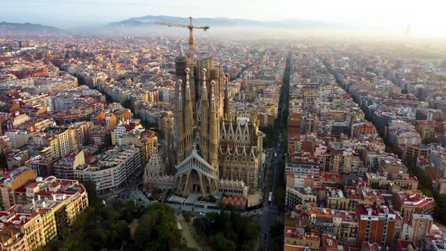 Temple Expiatori La Sagrada Familia in Barcelona, Catalonia, Spain. Flying around the architectural masterpiece of Gaudi in the sunrise, UHD, 4K