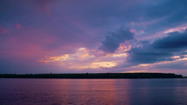 Cloudy sunset over the lake, time-laps