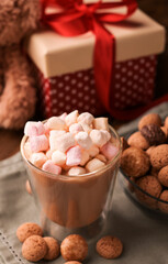 latte, espresso with milk and marshmallows. Festive drink. Dutch holiday Sinterklaas. kruidnoten cookies sweets, chocolate and a gift for the child. Children party Saint Nicholas day five december