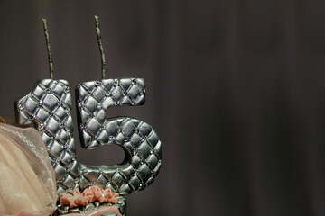 sculpture of number fifteen in silver color