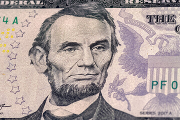 Close-up of 5 us dollar bill. Portrait of President Abraham Lincoln on the five us dollars banknote.