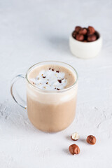 Vegan mochaccino with chocolate, hazelnuts and coconut milk in a glass mug.