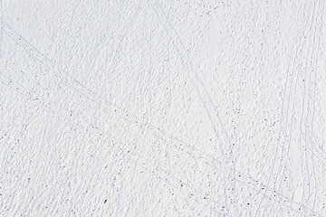 footprints and sledge marks on the snow viewed from drone above