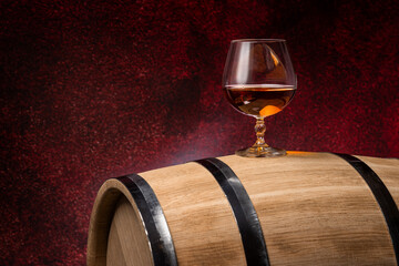 Wooden barrel with glass of brandy