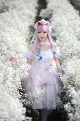 Beautiful young woman with white lolita dress with flowers garden Japanese fashion