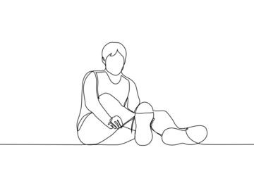 man sitting on the floor tying the laces on sneakers - one line drawing vector. sportsman training concept