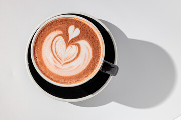 Top view of coffee with red foam and picture