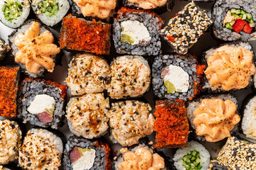 Photo of fresh maki sushi platter with a lot of variety.