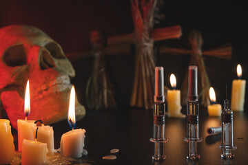 Voodoo and candles. Skull and syringes on a black background. People management concept. Compulsory...