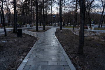 sidewalk in the park in the evening, close-up, City park with paths, Landscape