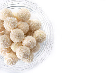 Homemade coconut balls in crystal bowl isolated on white background