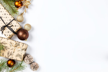 Christmas gifts with balls, pine cones and spruce branches on white background top view. Flat lay. Christmas and new year holiday background. Xmas greeting card concept