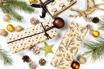 Christmas gifts with balls, pine cones and spruce branches on white background top view. Flat lay. Christmas and new year holiday background. Xmas greeting card concept
