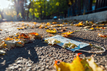face mask thrown on the ground. Environmental plastic pollution. Waste during COVID-19.