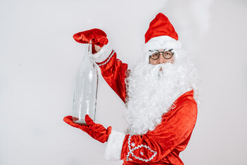 Santa Claus holding a bottle. Glass transparent Bottle.