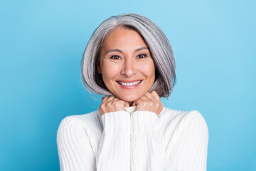 Photo of aged lovely woman arms touch warmth jumper harmony isolated over blue color background