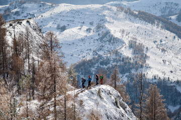 Hikers on the top of a cliff at Scarita Belioara, Transylvania, Romania
