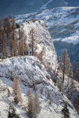 Hikers on the top of a cliff at Scarita Belioara, Transylvania, Romania