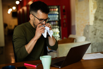 Angy businessman using laptop in his office. Tired man working in the office