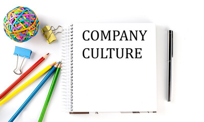 Notebook ,pencils,pen and rubber band with text COMPANY CULTURE on the white background