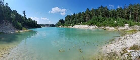 Trees grow on the banks of the turquoise lake