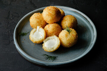 fried mozzarella balls on white plate