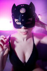 Portrait of sexy beautiful woman in leather cat mask for bdsm games