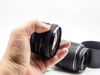 old photo lens in the hand of a man on a white background