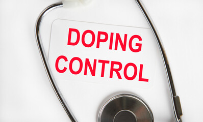 on the business card in red text the text DOPING CONTROL, next to the stethoscope.