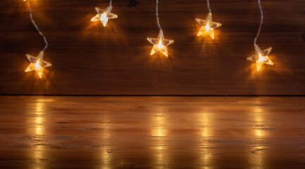  string of bright orange stars. wooden background. Christmas decoration