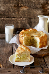 Homemade potato pie. Yeast dough. Wooden background, side view.