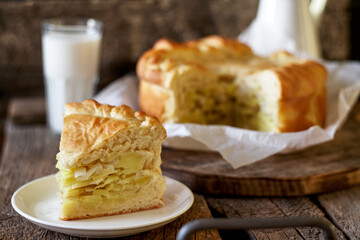 Homemade potato pie. Yeast dough. Wooden background, side view.