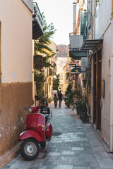 Urban are with restaurants and bars on narrow street in famous Mediterranean town of Nafplio, Greece