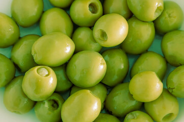 Pile of green pitted olives as an appetizer, as an ingredient or for cocktails